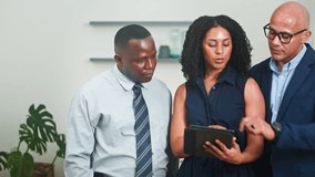 Diverse Business Team Collaborating on a Digital Tablet in a Modern Office Meeting - Powered by Shutterstock - Get 15% off with code: PIKWIZARD15