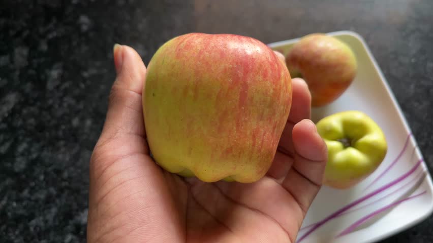 Hand Holding a Fresh Red Apple Close-Up
