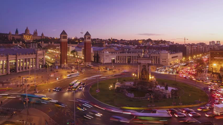 A dynamic timelapse video captures the bustling flow of traffic and city life on Barcelona