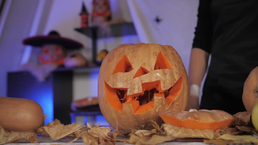 Carving pumpkins with woman hands preparing halloween jackolantern