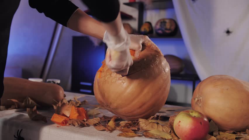 halloween pumpkin carving with knife closeup