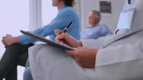 Female doctor sits on chair and writes down instruction while making a diagnosis. Healthcare specialists doctor attend professional medical seminar, listen to lectures, take notes, hone their skill - Powered by Shutterstock - Get 15% off with code: PIKWIZARD15