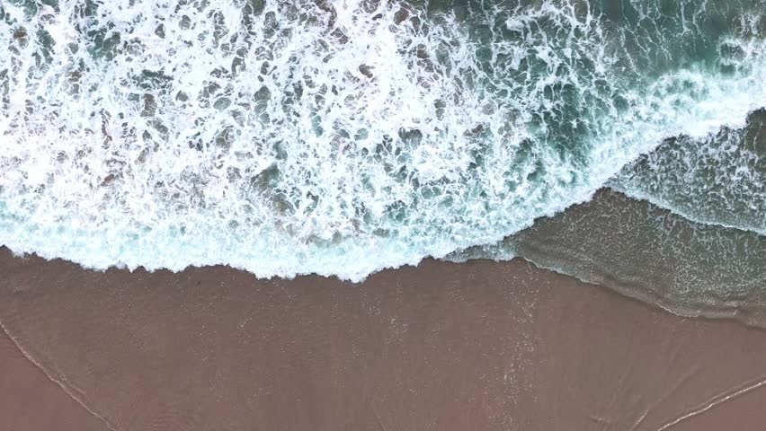 Aerial nature top down ocean waves on the beach southern Del Mar San Diego California CA USA