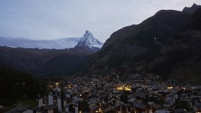 Evening view of Zermatt mountain town with glowing lights and the Matterhorn peak in the background during blue hour. Peaceful night scene in the Swiss Alps, Switzerland - Powered by Shutterstock - Get 15% off with code: PIKWIZARD15