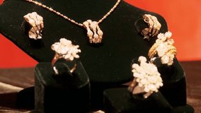 Luxury gold necklace and rings set adorned with diamonds and precious stones, showcasing elegance, craftsmanship, and timeless beauty for special occasions. - Powered by Shutterstock - Get 15% off with code: PIKWIZARD15