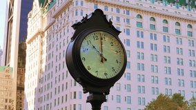 Time-lapse of a city clock showing the passage of time in an urban environment with moving clouds and changing daylight. - Powered by Shutterstock - Get 15% off with code: PIKWIZARD15