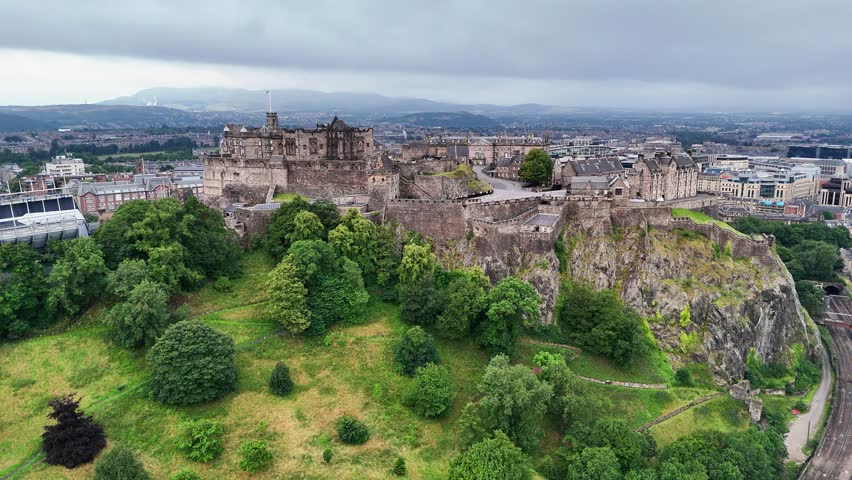 Overhead view of edinburgh castle surrounded by greenery in scotland during overcast summer weather
