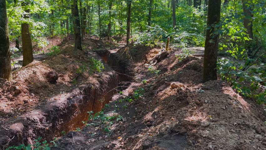 Trenches for the military in the forest. A real war. Defensive structures for soldiers, infantrymen.