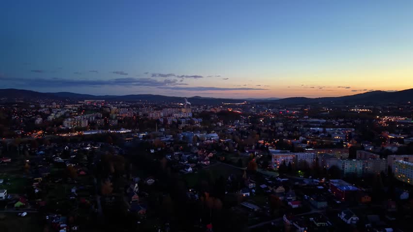 urban dusk skyline with lights, calm evening city view showcasing illuminated rooftops and distant