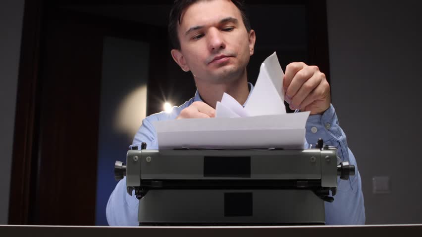 Man reading a letter, holding it above an old mechanical typewriter with paper, immersing himself in the written message from a bygone era of thoughtful communication