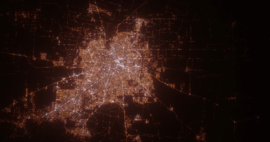 Cordoba (Argentina) top view at night. Aerial view on modern city from space. Camera is flying above the city, moving forward. Vertical video. The north is on the left side
