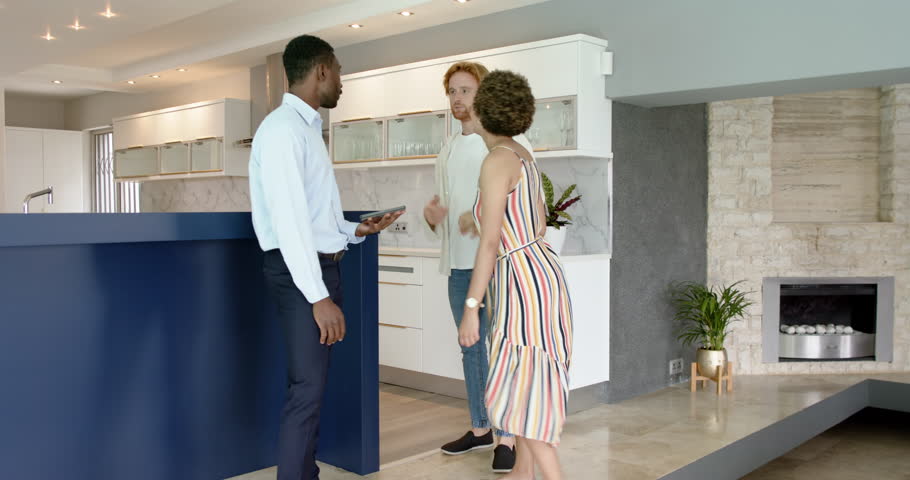 Happy and couple and male estate agent doing a house tour, talking, signing a contract and shaking hands. Moving house, housing and domestic life concept.