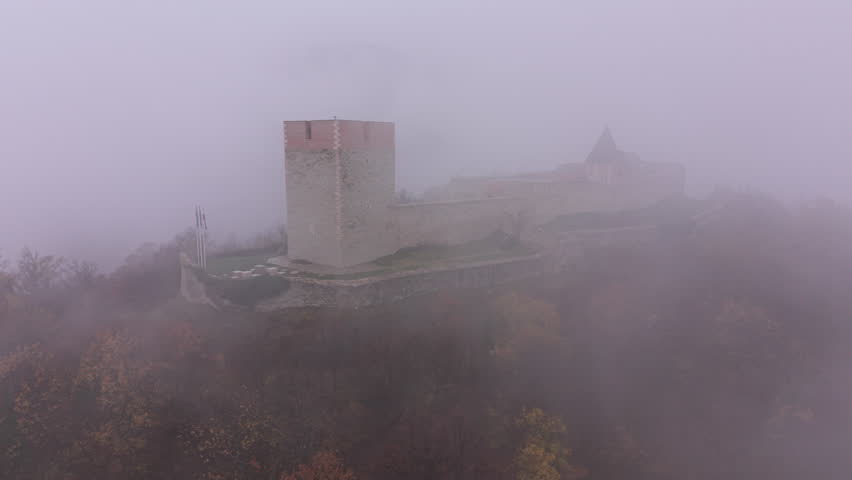 Short 4K wide drone orbit of Medvedgrad Fortress in clouds and fog, Zagreb, Croatia. D-LOG M, DJI Mini 5 Pro. Aerial footage for travel and cinematic use.