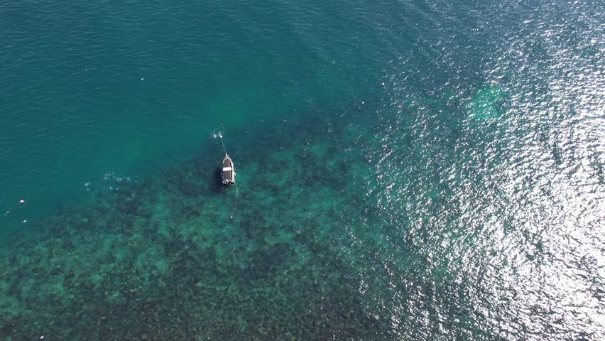 Elevated view of small tourist boat between Cook Island and Fingal Head causeway, northern New South Wales, Australia