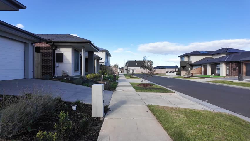 Residential street in Wyndham Vale, Victoria, Australia, with modern houses, driveways, and a quiet suburban neighborhood. Concept of new housing development, real estate, and community in Melbourne