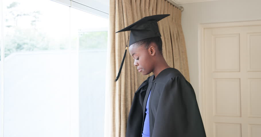 Graduating students in caps and gowns celebrating achievement at home. Graduation, celebration, education, academic, ceremony