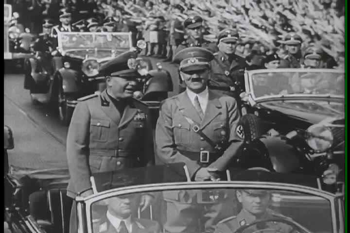 1940s - Adolph Hitler riders through Germany to meet Neville Chamberlain.