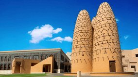 Traditional dovecote tower in Katara Cultural Village, Doha, Qatar, showcasing unique Middle Eastern architectural design with geometric patterns and wooden perches for birds.Dovecotes in Katara cultu - Powered by Shutterstock - Get 15% off with code: PIKWIZARD15