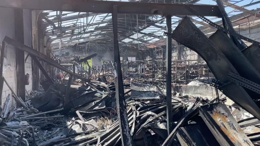 Devastating aftermath of a building fire with smoldering ruins
