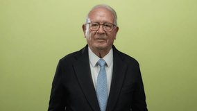 Senior man in business suit gestures with hands against isolated yellow background expressing confidence and professionalism. - Powered by Shutterstock - Get 15% off with code: PIKWIZARD15