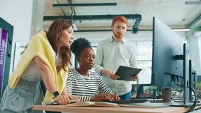 Group of coworkers standing near desk reviewing graphs on clipboard while comparing data on monitor. Team analyzing statistics and updating online reports in bright collaborative office. - Powered by Shutterstock - Get 15% off with code: PIKWIZARD15