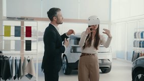 Manager providing innovative method for selecting auto. Potential client using VR headset while choosing vehicle. Learning information about car model with high-tech. Modern customer interaction. - Powered by Shutterstock - Get 15% off with code: PIKWIZARD15