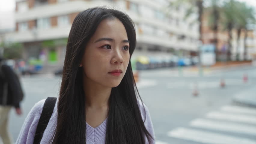 Woman outdoors surprised street urban city expression emotion sweater asian pedestrian shock