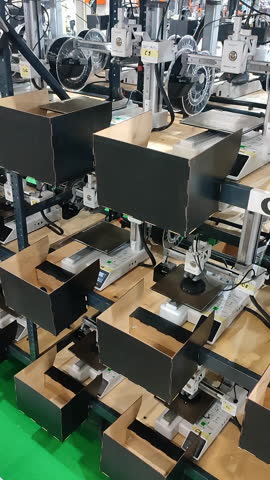 Many 3D printers printing object. 3D printers simultaneously printing model from molten plastic. 3D printers creating shape from plastic flowing out of extruder. Vertical