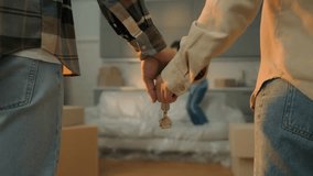 Happy African couple holding keys to their new home while their child joyfully jumps nearby, celebrating family, success, and the excitement of moving day. - Powered by Shutterstock - Get 15% off with code: PIKWIZARD15