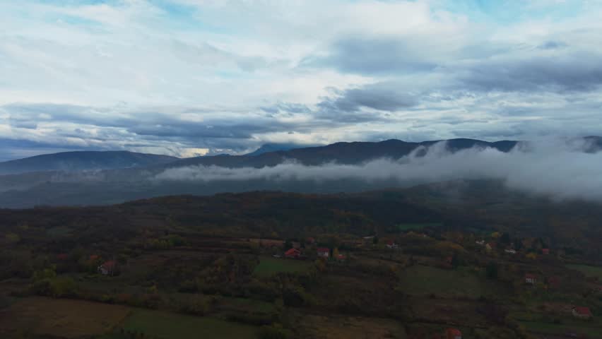 Beautiful view of mountains shrouded in clouds, capturing the serene landscape at dusk.