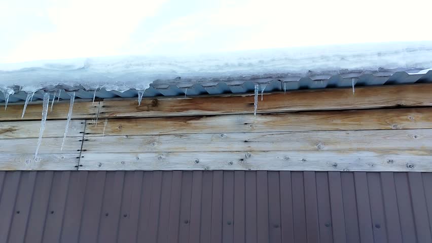 Textured wood boards and icicles camera movement right to left atmospheric background for titles travel b roll climate resilience and extreme weather