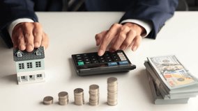 Real estate agent or investor, calculating or analyzing financial data related to property investment. Themes of saving, investing, and the financial aspects of purchasing a home or property. - Powered by Shutterstock - Get 15% off with code: PIKWIZARD15