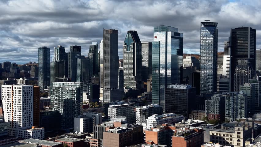 Aerial view of Montreal Old Port, downtown, historic buildings and waterfront under blue sky. g.