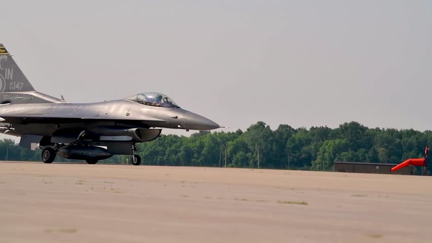 Heading for Takeoff: F-16 Fighter Jet Moves Slowly and Casually on the Airbase