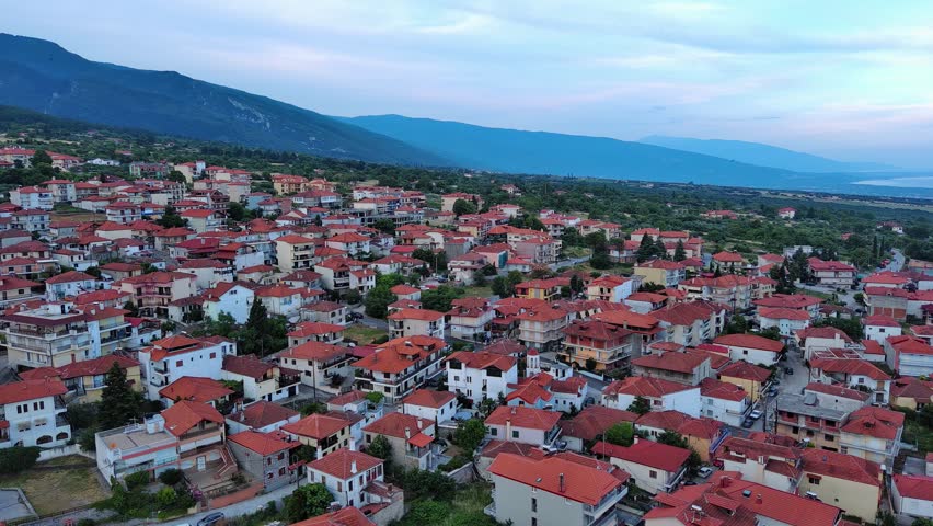 Greek town of Litochoro with small houses against the backdrop of the Mount Olympus and a cloudy sky