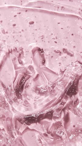 Liquid serum gel on pink background, cosmetic texture with bubble. Moisturizing beauty care products concept.