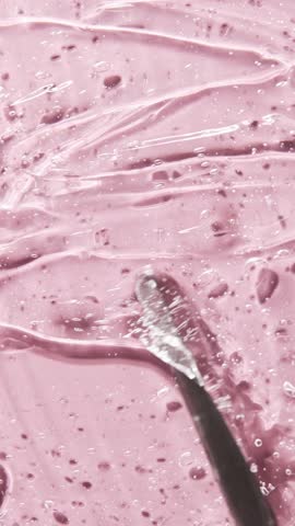 Liquid serum gel on pink background, cosmetic texture with bubble. Moisturizing beauty care products concept.