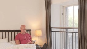 unhappy senior man suffering from insomnia, reading smartphone, poor sleep hygiene, Nighttime struggles, Health and aging, challenges quality sleep, technology use before bed, mental distress, - Powered by Shutterstock - Get 15% off with code: PIKWIZARD15