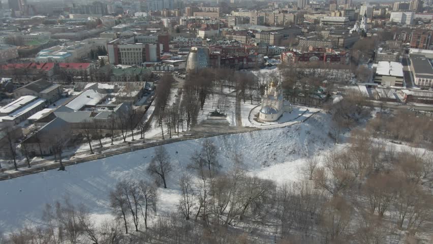 Drone descending toward monument and chapel in winter park