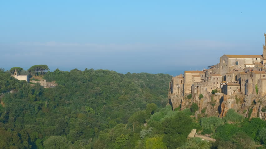 Medieval italian town pitigliano built on tuff cliff. Picturesque panoramic view of the ancient medieval town of pitigliano, built on a tuff rock cliff with its historic buildings in tuscany, italy