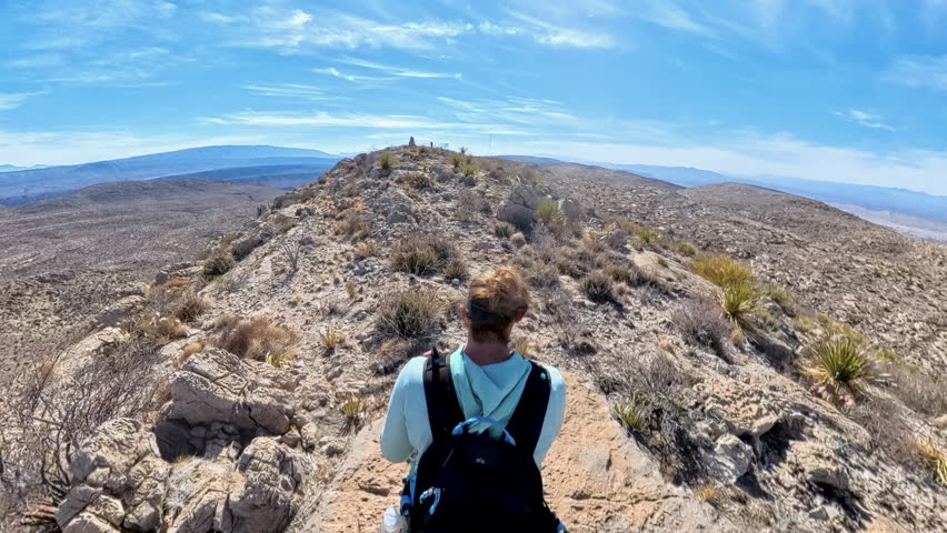 Overhead of Woman Hiking Across Rocky Desert Mountain in Big Bend