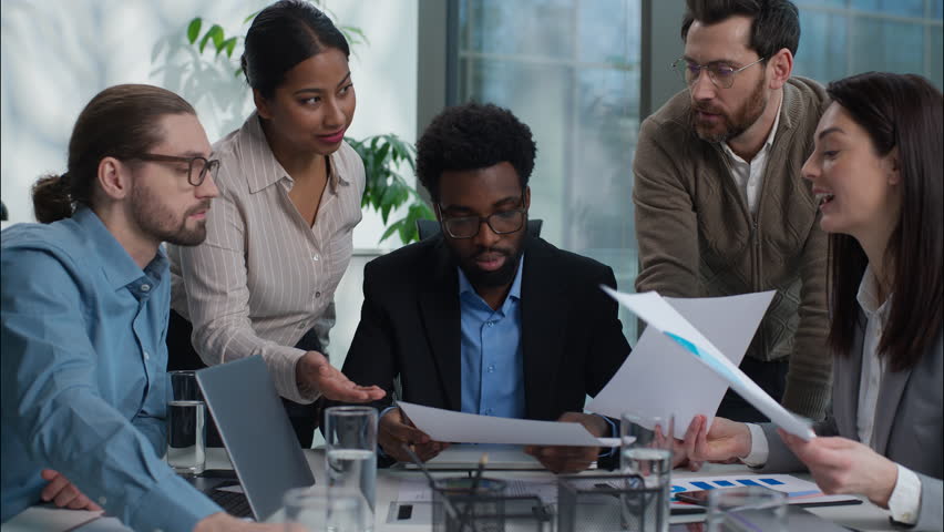 Multiethnic diversity business team Indian businesswomen Caucasian African businessmen men women coworkers office workers discuss strategy plan paperwork document briefing analysis colleagues talking - Powered by Shutterstock - Get 15% off with code: PIKWIZARD15