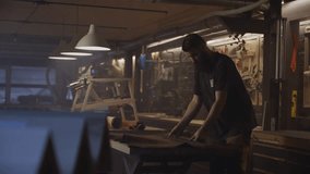 A craftsman works carefully with a large sheet of leather in a workshop filled with tools, showcasing precision, craftsmanship, and traditional leatherworking techniques. - Powered by Shutterstock - Get 15% off with code: PIKWIZARD15