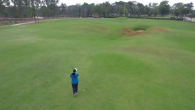 Drone view of professional female golfer playing on scenic golf course. Attractive beautiful woman enjoy outdoor recreation with light exercise and sport lifestyle while playing golf at course ground. - Powered by Shutterstock - Get 15% off with code: PIKWIZARD15