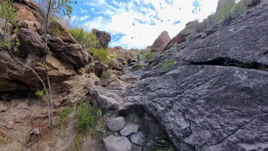 Woman Hikes Down Rocks in Wash in Big Bend