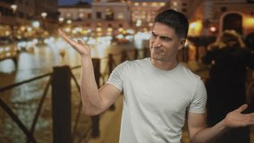 Man shrugging with palms up on illuminated city street at night facing blurred traffic lights; confusion. - Powered by Shutterstock - Get 15% off with code: PIKWIZARD15
