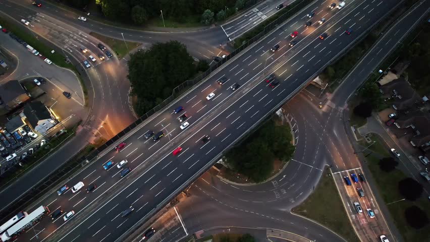 Aerial view of luxury modern glass tower surrounded by city skyline.