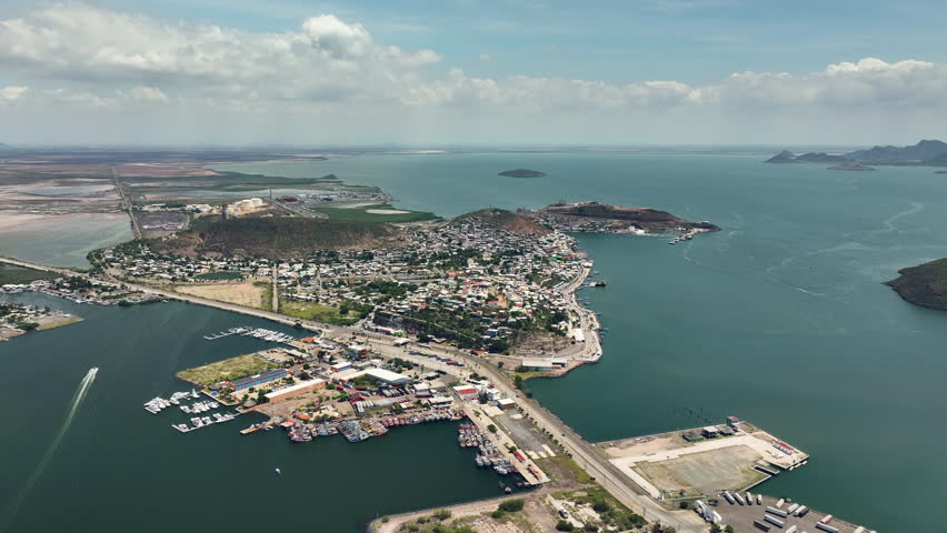 Drone flying backwards over the Topolobampo village, sunny day in Sinaloa, Mexico