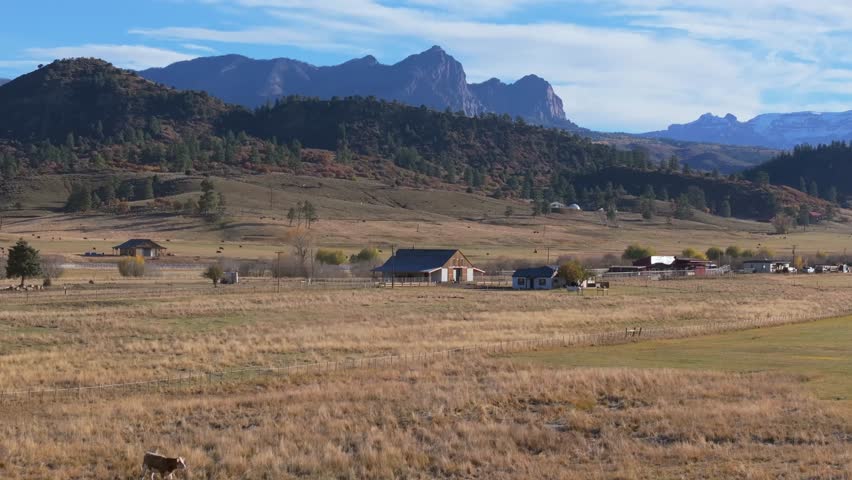 Scenic Colorado farm with mountains, rural life, peaceful and vast landscape
