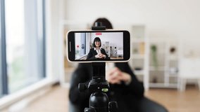 Caucasian woman recording video blog about business concepts and ideas using smartphone camera. Shows creative workspace with natural lighting for content creation and technology usage. - Powered by Shutterstock - Get 15% off with code: PIKWIZARD15